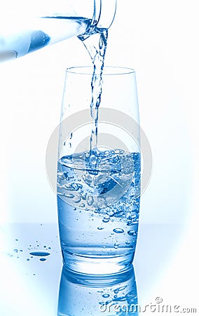 Pouring water on a glass Stock Photo