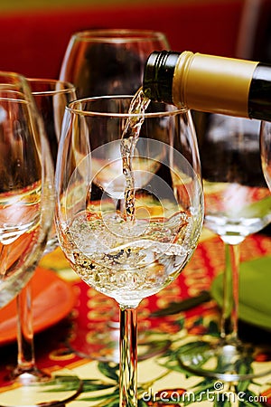 Pouring white wine Stock Photo