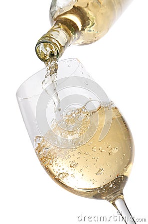 Pouring white wine into a glass Stock Photo