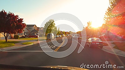 POV: Driving past expensive houses in the suburbs at beautiful autumn sunrise. Editorial Stock Photo