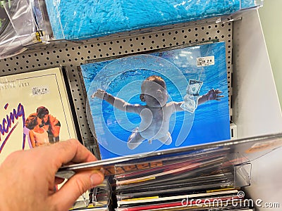 POV: Male Hand Buying Nirvana Iconic CD Editorial Stock Photo