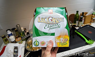 POV male hand holding package with Licorne Elsass panache light drink on the Editorial Stock Photo