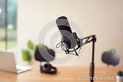 POV Of Microphone In Room At Home To Record Podcast Or Radio Broadcast With Laptop And Headphones Stock Photo