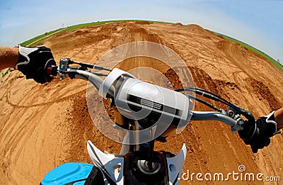 A motocrosser jumping from his perspective Stock Photo