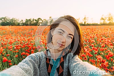 POV of smiling woman taking selfie in flower field. Stock Photo