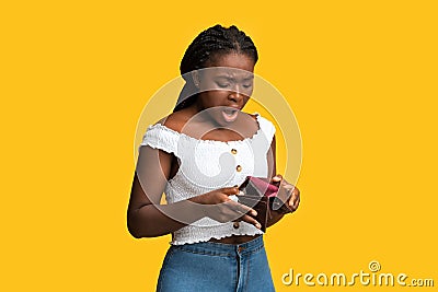 Poverty and absence of money. Shocked african american woman checking empty wallet Stock Photo
