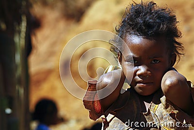 Poverty, portrait of a poor little African girl lost in deep tho Stock Photo