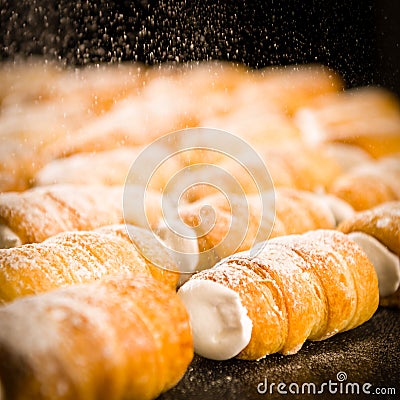 Powder sugar falling on to cream horns Stock Photo