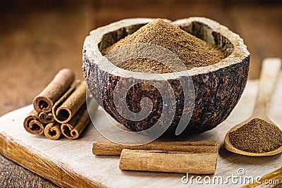 Powdered cinnamon and stick, in a rustic wooden bowl, exotic cinnamon from Brazil Stock Photo