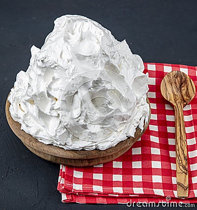 Powdered cream Powder Cream whipped cream in plate on wooden floor. Cooking buttery cream on kitchen Stock Photo