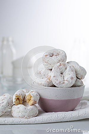 Powdered sugar mini donuts, white and pink bowl Stock Photo