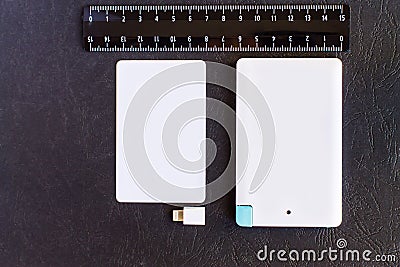 Power bank small mini size at credit card and rulers on black ba Stock Photo