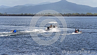 A power boat pulling children on tubes at a local dam Editorial Stock Photo