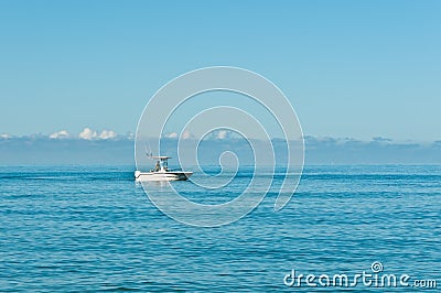 Power boat, trolling in the Gulf of Mexico with a male steering and fishing Stock Photo