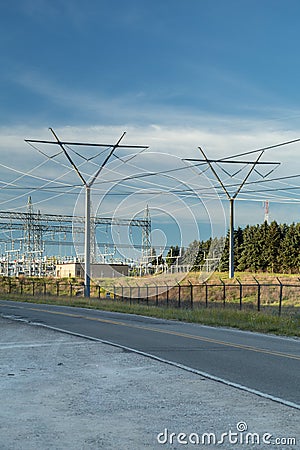 Power Electrical Lines From Hydro Electric Plant by Road and Power Station Stock Photo