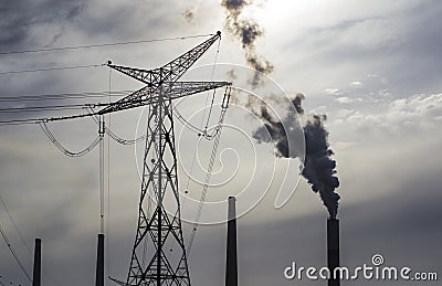 Power line and power plant stacks at background Stock Photo