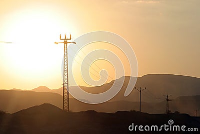 Power lines and array of electric pylons Stock Photo