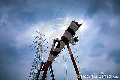 Power lines and industrial lifting equipment with a heavy and cl Stock Photo