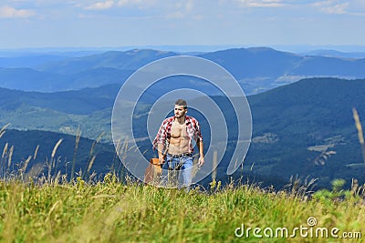 Power of Music. sexy man with guitar in checkered shirt. hipster fashion. western camping and hiking. happy and free Stock Photo