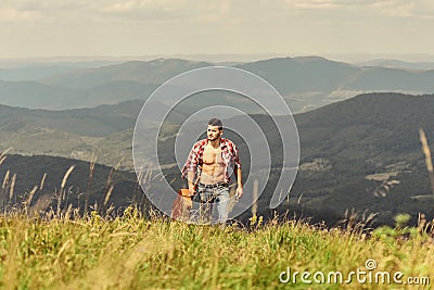 Power of Music. sexy man with guitar in checkered shirt. hipster fashion. western camping and hiking. happy and free Stock Photo