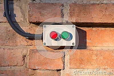 Power on and off buttons placed on a brick wall. Electrical equipment installation concept Stock Photo