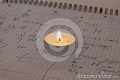 Power outage. Home school assignments are about candles. Elementary school math problems and a candle. Stock Photo