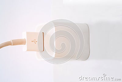 Power outlet with Phone charger in on socket wall, charging.selective focus Stock Photo