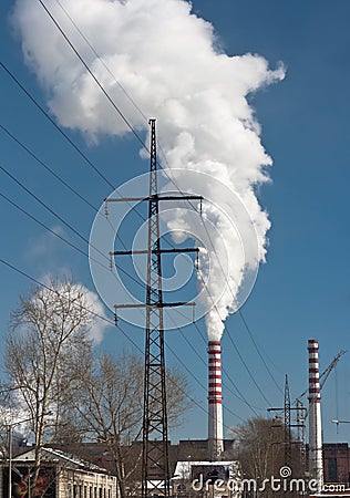 Power plant smoking stacks and tower Stock Photo