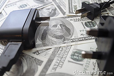 Dollar notes background and electrical plug Stock Photo