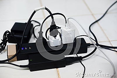 Power plug in full , power outlet multiple socket - overload charger extension cord cable connector Stock Photo