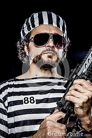 Power, Prison riot concept. Man holding a machine gun, prisoner Stock Photo