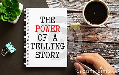 THE POWER OF STORYTELLING - text on notepad on wooden desk. Stock Photo