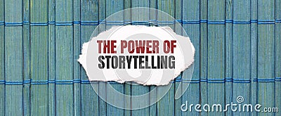 THE POWER OF STORYTELLING text on the piece of paper on the green wood background Stock Photo