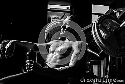 Power, strength and healthy lifestyle, sport. Resting time. Tired sporty man resting after training. Man with bottle of Stock Photo