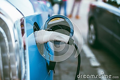 Power supply connect to electric vehicle Stock Photo