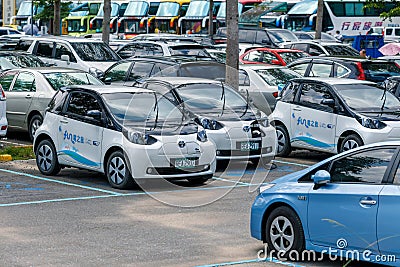 Power supply connects to plug-in electric vehicle or electric car at charging kiosk in car park in Sun Moon Lake area Editorial Stock Photo