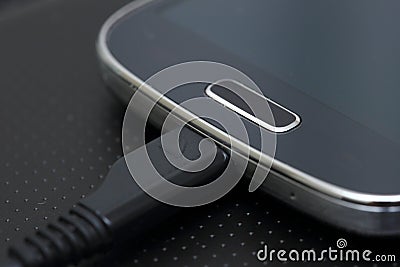 USB cable on modern smartphone Stock Photo