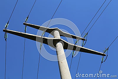 Power transmission masts against a blue sky Stock Photo