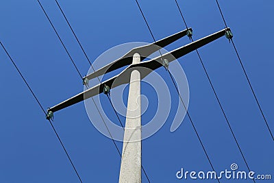 Power transmission masts against a blue sky Stock Photo