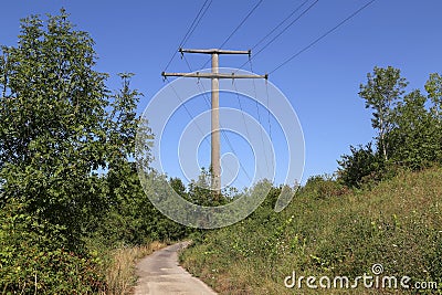 Power transmission masts against a blue sky Stock Photo