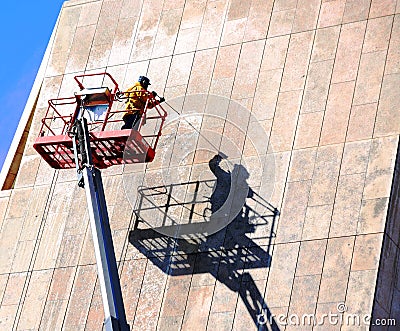 Power Washing a Building Editorial Stock Photo