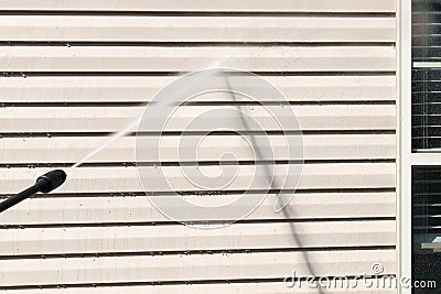 Power washing. House wall siding cleaning with high pressure water jet. Stock Photo