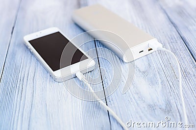 Powerbank charging white smartphone Stock Photo