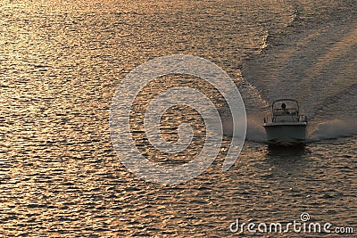 Powerboat at sunset Stock Photo