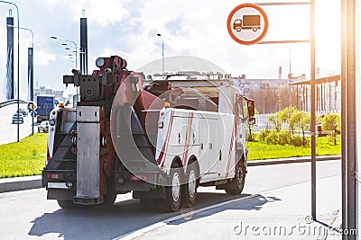 Powerful big rig semi truck tractor tows driving on city highway Stock Photo