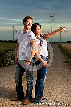Powerful couple in front of windmill Stock Photo