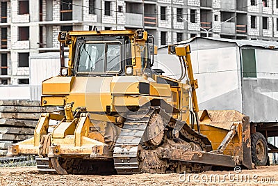 Powerful crawler bulldozer close-up at the construction site. Construction equipment for moving large volumes of soil. Modern Stock Photo