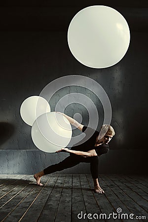 Powerful dancer performing in front of the dark wall Stock Photo