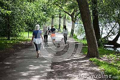 Powerful happy elderly people are walking, running in the park Editorial Stock Photo