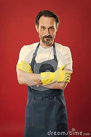 Powerful helper. On guard of cleanliness. Cleaning service and household duty. Lot of work. Man in apron with gloves Stock Photo